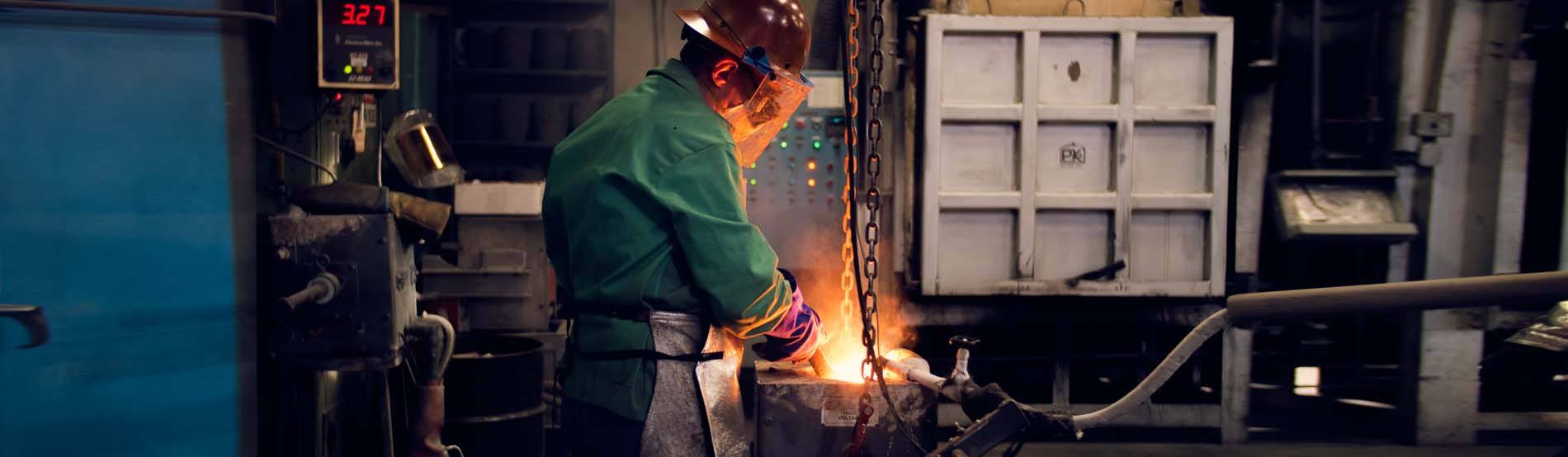 worker casting metal